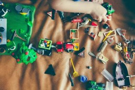 image of a toys strewn about on a bed.