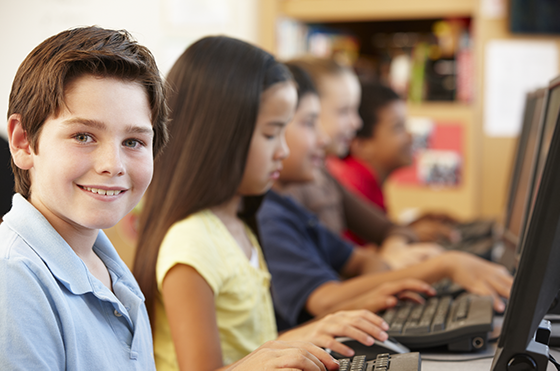 elementary students on computers at school